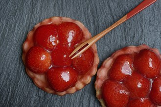 Topped strawberry tarts with a fork