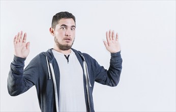 Scared man with raised hands isolated. Person with scared face with raised hands