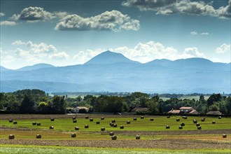 View of the Chain of Volcanoes and Limagne plain under a vibrant sky in Puy-de-Dôme,