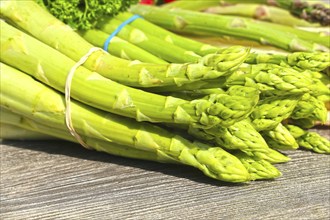 Green asparagus decorated on a rustic wooden table