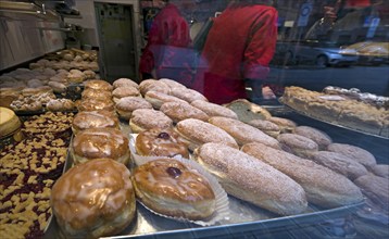 Various doughnuts in the shop window of a pastry shop, Nuremberg, Middle Franconia, Bavaria,