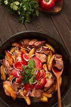 Ojakhuri, Traditional Georgian dish, fried potatoes with meat, in a clay frying pan, top view, no