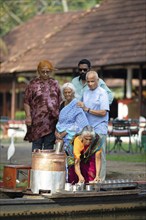 Tealady, 83 years old, making Indian tea on her boat, Backwaters, Kumarakom, Kerala, India, Asia