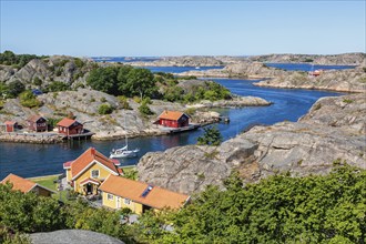 View of a rocky archipelago with boats and houses on the Swedish west coast on a beautiful summer