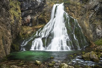 The Golling waterfall (Schwarzbachfall, Schwarzenbachfall) in autumn. Rocks with moss. Tennengau,