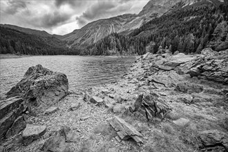 Obernberger See, mountain lake, landscape of the Stubai Alps, weather mood, cloud mood, black and