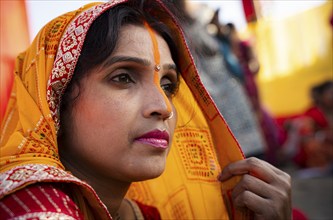 Hindu devotees perform rituals as they offer prayers to the Sun god in the bank of Brahmaputra