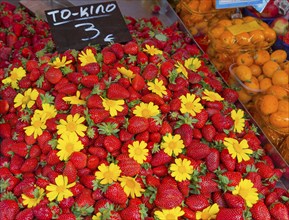 Market stall with fresh strawberries and yellow flowers, price tag available, market, Nafplio,