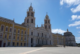 Monumental baroque architecture with two towers and detailed façade under a clear sky, National