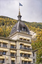 A luxurious hotel building in front of an autumnal mountain landscape, Lake Brienz, Interlaken,