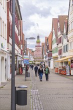 A lively pedestrian zone with half-timbered houses and people strolling along the street, Kirchheim