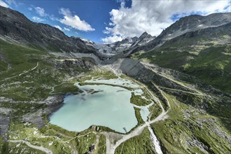 Glacial lake Lac de Chateaupre, lake just below the Moiry glacier, river arms in blue water, dam to