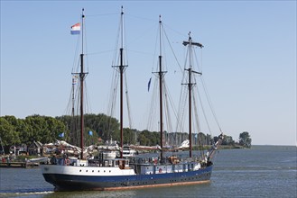 Old sailing ship, traditional sailing ship leaves the harbour of Enkhuizen, North Holland, West