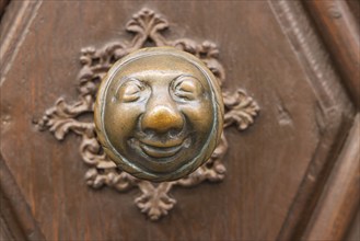 Stahlesches Schwesternhaus in the street Eisgrube in Bamberg. Doorknob with a cheerful face, known