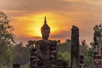 Sunset at a Buddha statue of the temple Wat Mahathat, UNESCO World Heritage Sukhothai Historical