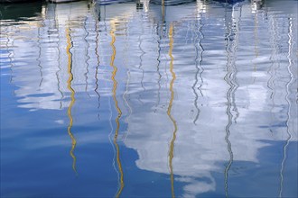 Water reflection, sailing boats in the harbour of Saint Tropez, Var, French Riviera,