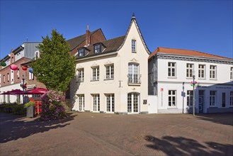 Historic building under a blue sky at the intersection of Hohe Straße and Bahnhofstraße in Rhede,