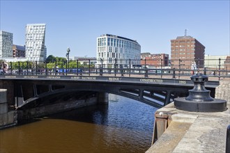 Bridge over a river with modern buildings in the background, Liverpool