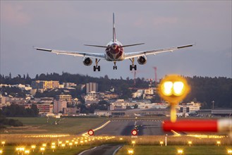 Eurowings aircraft landing in the evening with illuminated runway. Zurich Airport, Switzerland,