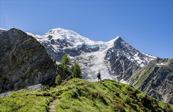 Mountaineer on a hiking trail in front of mountain landscape with glacier, view of glacier Glacier