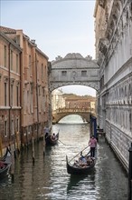 Venetian gondolas on the Rio di Palazzo canal with Bridge of Sighs, Venice, Veneto, Italy, Europe