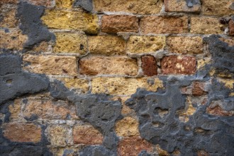 Grey plaster crumbling from a dilapidated brick wall, Venice, Veneto, Italy, Europe