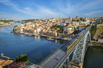 View of Porto city and Douro river and Dom Luis bridge I with metro tram from famous tourist