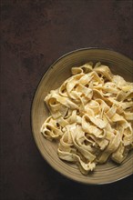 Fettuccine, tagliatelle, in creamy garlic sauce, Italian traditional cuisine, pasta carbonaro