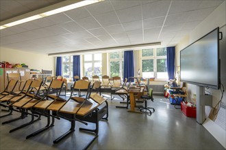 Classroom of a fourth grade, after school, the building is older but in good condition, modern