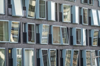 Box-shaped windows, at different angles, façade of a residential building in Rotterdam, Netherlands