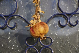 Pomegranate on ornate blue metal background, decorative detail, front door, detail, Pigadia, town