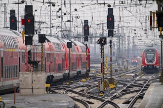 Railway tracks with regional trains, after freezing rain, in front of Frankfurt main station,