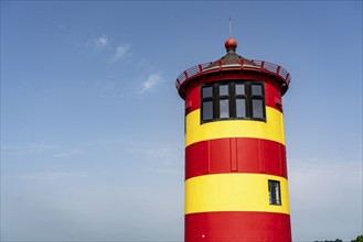 The Pilsum lighthouse on the North Sea dyke near Greetsiel, East Frisia, Lower Saxony, Germany,