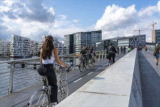 Cyclists on the Bryggebroen cycle and footpath bridge over the harbour, Sydhavnen, Copenhagen is