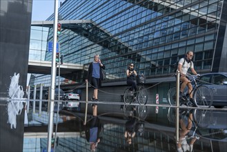 Cyclists on the cycle path on Christians Brygge Street, at the Black Diamond, Danish Royal Library,