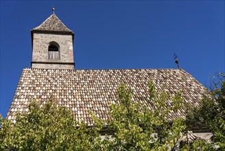 Church in the village of Montiggl, colourful shingle roof, on the South Tyrolean Wine Road, near