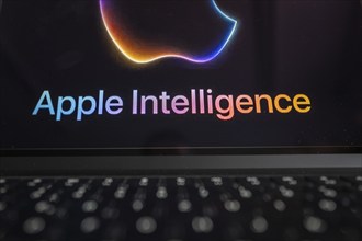 Apple logo in bright neon colours on a Macbook with illuminated keyboard and the text 'Apple