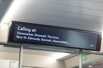 Electronic passenger information sign onboard train service Ipswich to Cambridge, England, UK