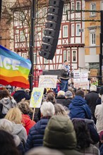 Demonstration with speaker and rainbow flag for peace and diversity, demonstration against the