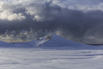 Cloudy mood and snowstorm over an old volcano, snow, winter, Neshraun, Snaefellsnes, Vesturland,