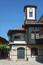 Tower with clock on a traditional building under a clear blue sky, clock tower, Black Sea, Nesebar,