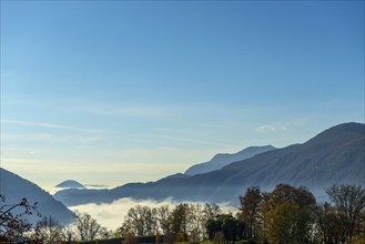 Mountain View over Lake Lugano with Cloudscape and Sunlight and Clear Sky in Lugano, Ticino in