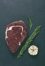 Raw steak, beef steak, rib eye steak, on the table, top view, no people, on a dark background