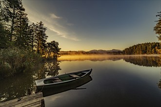 Boats in the autumnal Schmutter Weiher in the Allgäu near the municipalities of Halblech,