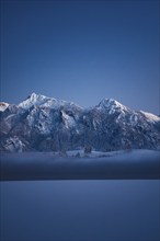 Shortly after sunset, twilight at Lake Hopfensee in the Allgäu in Bavaria in a winter landscape,