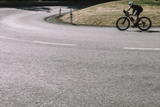 Road bike rider in spring in the Allgäu against the picturesque backdrop of the Alps, Bavaria,