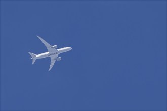 Boeing 787-8 Dreamliner jet aircraft of Qatar airlines flying in a blue sky, England, United