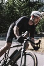 Road bike rider in spring between Lechtal and Tannheimer Tal in front of picturesque scenery of the