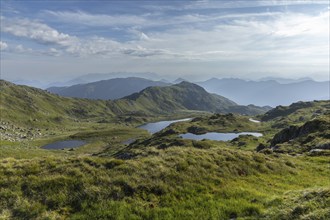 Vast mountain landscape with glittering mountain lakes under a blue sky, Neukirchen am