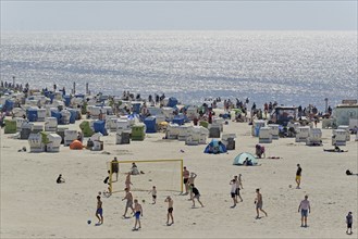 View of the beach with beach chairs and areas for sports, blue sky, North Sea, Norddeich, Lower